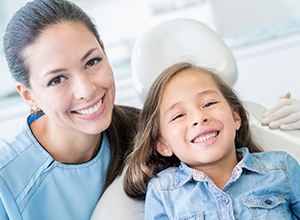 dentist and kid in dental chair smiling
